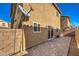 Stucco home backyard featuring a paved patio, exterior lighting, and brick wall at 6217 Red Jamboree Ct, Las Vegas, NV 89130