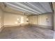 Spacious garage featuring a concrete floor, overhead lighting, and access door at 6217 Red Jamboree Ct, Las Vegas, NV 89130