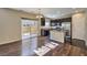 Open-concept dining and kitchen area featuring hardwood floors, stainless appliances, and sliding door at 6217 Red Jamboree Ct, Las Vegas, NV 89130