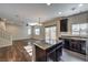 Kitchen and living area with island, stainless appliances, and wood-look flooring at 6217 Red Jamboree Ct, Las Vegas, NV 89130
