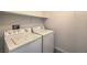 Functional laundry room includes a washer, dryer, and shelving for added storage at 6217 Red Jamboree Ct, Las Vegas, NV 89130