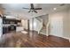 Spacious open-concept living area with hardwood floors, kitchen view, and staircase access at 6217 Red Jamboree Ct, Las Vegas, NV 89130
