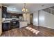 Open-concept floorplan with kitchen island, stainless appliances, and wood-look flooring at 6217 Red Jamboree Ct, Las Vegas, NV 89130
