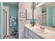 Bathroom featuring a large mirror, walk-in shower, and granite countertops at 6883 Tamarus St # 203, Las Vegas, NV 89119