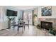 Dining area with a fireplace, stylish furniture, and access to the exterior at 6883 Tamarus St # 203, Las Vegas, NV 89119