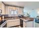 Kitchen with white cabinets, granite countertops, and modern appliances at 6883 Tamarus St # 203, Las Vegas, NV 89119