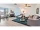 Inviting living room featuring a fireplace, modern flooring, and comfortable gray furniture at 6883 Tamarus St # 203, Las Vegas, NV 89119