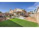 Inviting backyard space featuring artificial turf, a grill, patio furniture, and covered patio at 6982 Rusty Nail Way, Las Vegas, NV 89119