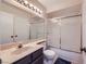 Well-lit bathroom with vanity, large mirror, and shower-tub combination with sliding glass doors at 6982 Rusty Nail Way, Las Vegas, NV 89119