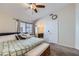 Cozy bedroom featuring carpet, ceiling fan, and large bed with decorative pillows and storage bench at 6982 Rusty Nail Way, Las Vegas, NV 89119