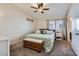 Cozy bedroom featuring carpet, ceiling fan, and large bed with decorative pillows and storage bench at 6982 Rusty Nail Way, Las Vegas, NV 89119
