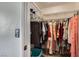 Walk-in closet with plentiful hanging storage and shelves, filled with neatly arranged clothes and shoes at 6982 Rusty Nail Way, Las Vegas, NV 89119