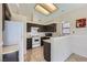 Bright kitchen featuring a gas range, tiled floors, and a breakfast bar at 6982 Rusty Nail Way, Las Vegas, NV 89119