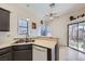 Open kitchen featuring stainless steel sink, dishwasher and backyard views at 6982 Rusty Nail Way, Las Vegas, NV 89119