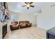 Inviting living room featuring neutral colors, tile floors, and a cozy fireplace at 6982 Rusty Nail Way, Las Vegas, NV 89119