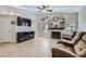Spacious living room featuring neutral colors, tile floors, and a cozy fireplace at 6982 Rusty Nail Way, Las Vegas, NV 89119