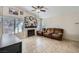 Comfortable living room featuring tile floors, a fireplace, and natural light at 6982 Rusty Nail Way, Las Vegas, NV 89119