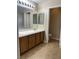 Bathroom featuring tile floors, double sinks and plenty of lighting at 7439 S Pioneer Way, Las Vegas, NV 89113