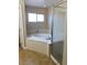 Relaxing bathroom featuring a soaking tub with tile flooring and glass enclosed shower at 7439 S Pioneer Way, Las Vegas, NV 89113