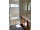 Bright bathroom featuring a tub-shower combination and a mirrored vanity with wood cabinets at 7439 S Pioneer Way, Las Vegas, NV 89113