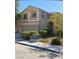 Charming two-story home with well-manicured landscaping and a welcoming facade at 7439 S Pioneer Way, Las Vegas, NV 89113
