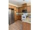 Functional kitchen with granite countertops, stainless steel appliances, and wood cabinetry at 7439 S Pioneer Way, Las Vegas, NV 89113