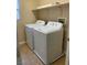 Functional laundry room equipped with a washer, dryer and storage shelf at 7439 S Pioneer Way, Las Vegas, NV 89113