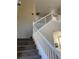 Carpeted staircase with white railing leading to the upper level of the home at 7439 S Pioneer Way, Las Vegas, NV 89113
