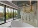 Spa-like bathroom showcasing a soaking tub, and a glass-enclosed shower with designer tile and outdoor access at 751 Wexler Ct, Las Vegas, NV 89107