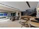 Open entertainment area with game table, bar with stools and a staircase to the upper level at 751 Wexler Ct, Las Vegas, NV 89107