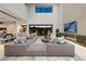 A high ceiling living room with modern decor, a fireplace, and access to outdoor living space at 751 Wexler Ct, Las Vegas, NV 89107