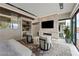 Luxurious bedroom featuring a fireplace, bar area, sitting area and sliding glass doors leading to a pool at 751 Wexler Ct, Las Vegas, NV 89107