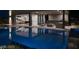 A stunning pool and outdoor entertaining area with a bar, lounge seating, and seamless access to the home at 751 Wexler Ct, Las Vegas, NV 89107