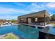 Modern outdoor pool area with lounge seating, outdoor kitchen, and access to multiple indoor living spaces at 751 Wexler Ct, Las Vegas, NV 89107