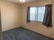 Cozy bedroom with a window and dark gray curtains allowing natural light at 774 Anne Ln, Henderson, NV 89015