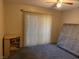 Neutral bedroom featuring a ceiling fan, vertical blinds, and neutral walls at 774 Anne Ln, Henderson, NV 89015