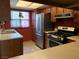 Functional kitchen featuring stainless steel appliances, wood cabinets, and a window for natural light at 774 Anne Ln, Henderson, NV 89015