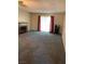 Bright living room boasts a cozy fireplace, soft carpet, and sliding doors providing ample light at 774 Anne Ln, Henderson, NV 89015