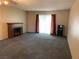 Spacious living room featuring a fireplace, carpet flooring, and sliding doors allowing natural light to flood in at 774 Anne Ln, Henderson, NV 89015