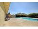 Serene community pool with inviting blue water, surrounded by lush greenery and a picnic table area at 774 Anne Ln, Henderson, NV 89015