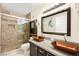 Bathroom featuring dual copper sinks, a granite countertop, and a luxurious glass-enclosed shower at 7950 W Flamingo Rd # 2142, Las Vegas, NV 89147