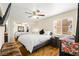 Bright bedroom with hardwood floors, a ceiling fan, and mirrored closet, creating a spacious feel at 7950 W Flamingo Rd # 2142, Las Vegas, NV 89147