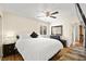 Comfortable bedroom featuring wood floors, a ceiling fan, and ample natural light from the window at 7950 W Flamingo Rd # 2142, Las Vegas, NV 89147