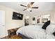 Bright bedroom boasts a mirrored closet, ceiling fan, and wood floors at 7950 W Flamingo Rd # 2142, Las Vegas, NV 89147