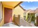 Apartment front door and stairway lead to a well-maintained complex with lush landscaping at 7950 W Flamingo Rd # 2142, Las Vegas, NV 89147
