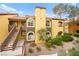 Exterior view of a stylish apartment building featuring a red tile roof and desert landscaping at 7950 W Flamingo Rd # 2142, Las Vegas, NV 89147