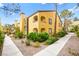 Charming two-story building with colorful exterior, landscaped gardens, and sidewalk at 7950 W Flamingo Rd # 2142, Las Vegas, NV 89147