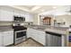 Well-equipped kitchen with stainless steel appliances and granite countertops open to the dining area at 7950 W Flamingo Rd # 2142, Las Vegas, NV 89147