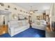Bright living room featuring modern sofas, hardwood floors, and a decorative mirror at 7950 W Flamingo Rd # 2142, Las Vegas, NV 89147