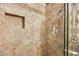 Walk-in shower features sandstone walls, glass door, rainfall showerhead, and an inset for toiletries at 7950 W Flamingo Rd # 2142, Las Vegas, NV 89147